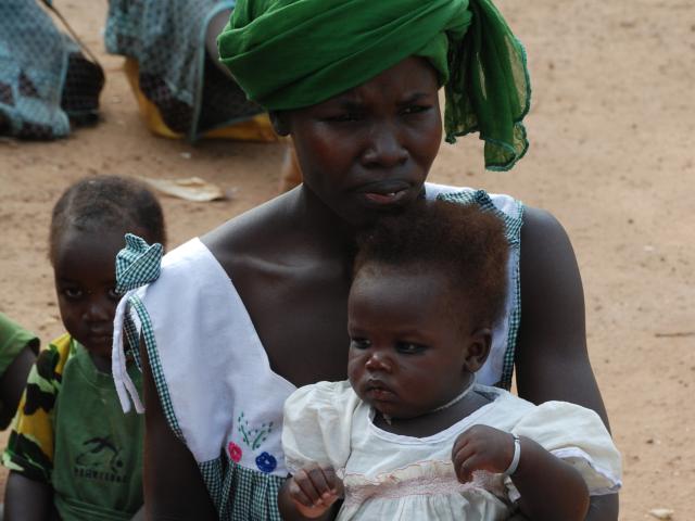 mother holding child in lap